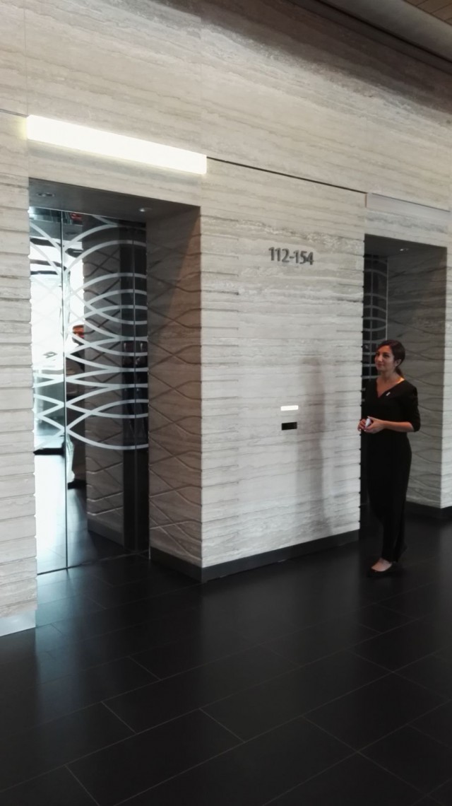 Assistentti opastaa meidät hissille.